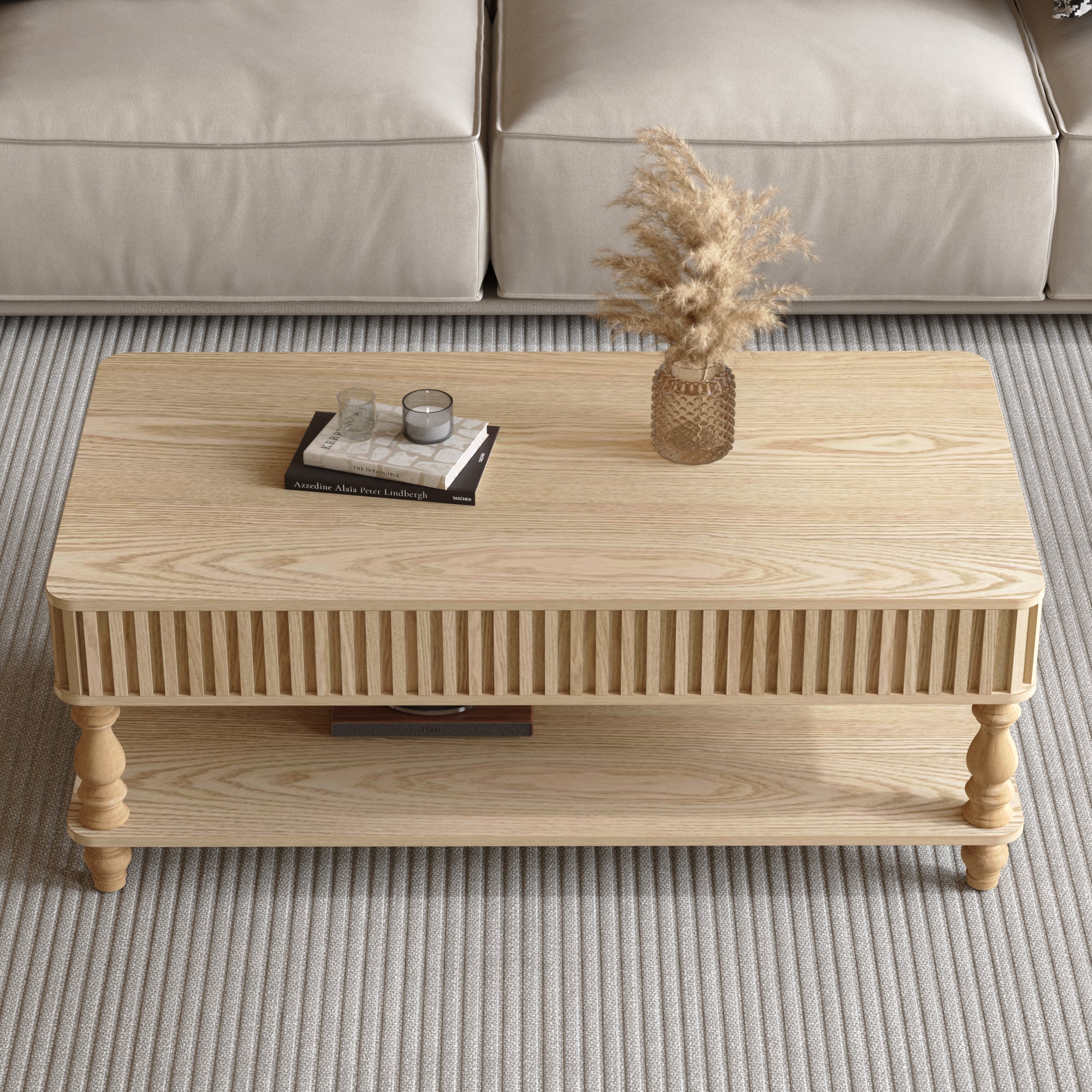 Top view of closed lift top coffee table with fluted wood detailing and decorative items, ideal for stylish storage solutions.