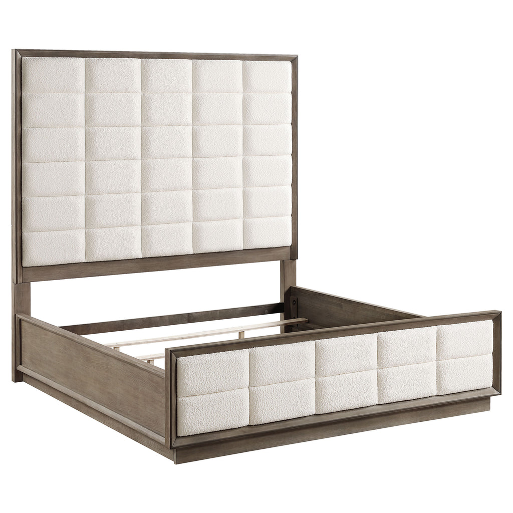 Eastern king panel bed in taupe oak with cream fabric, featuring a tall headboard and footboard with grid tufting.