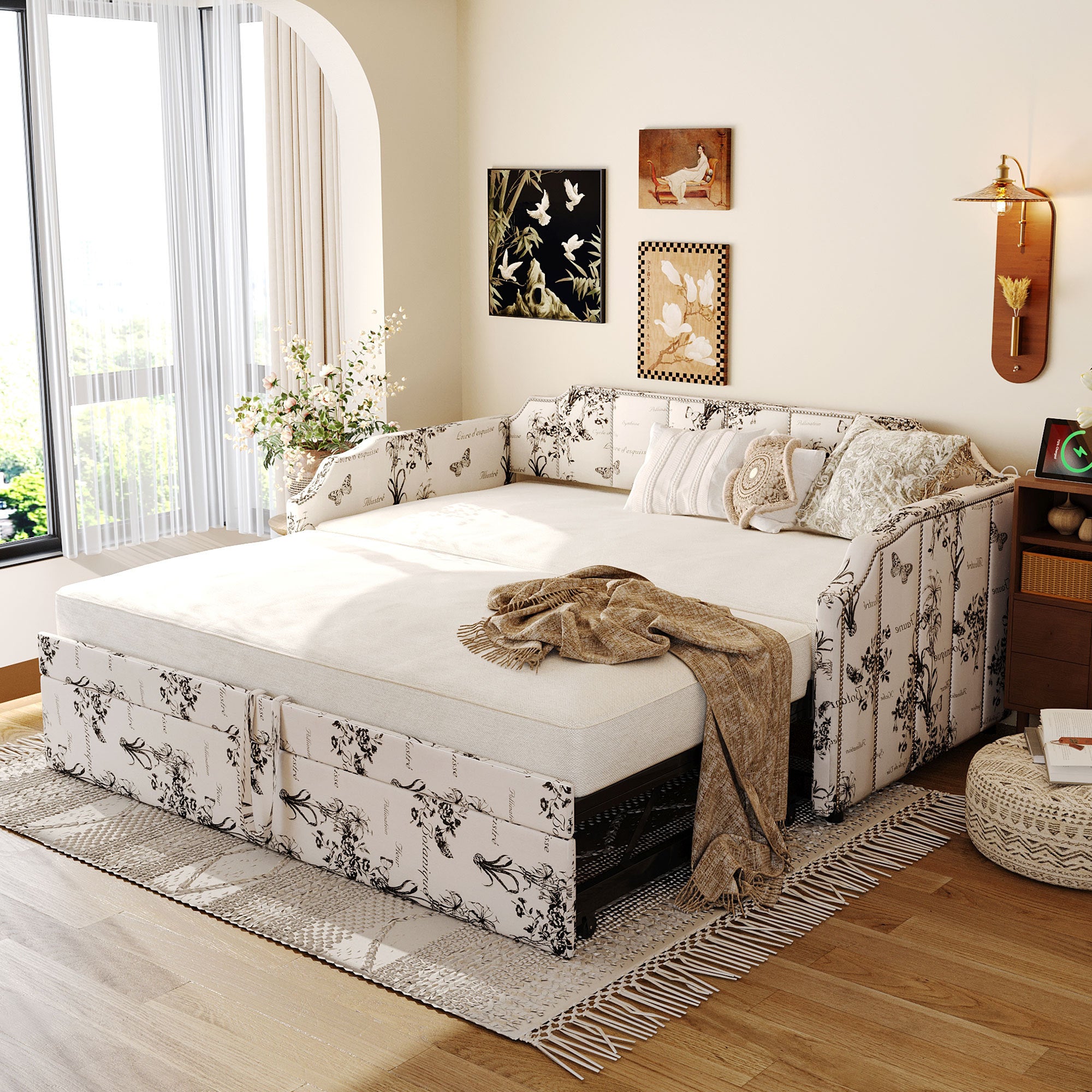 Upholstered twin daybed featuring a black-and-white botanical print, pop-up trundle, and integrated USB charging ports.