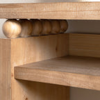 Interior corner of rustic console table with shelf, showing bead detail and solid wood construction.