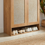 Bottom open shelf of rattan shoe cabinet storing shoes. Extra storage space ideal for frequently used footwear.