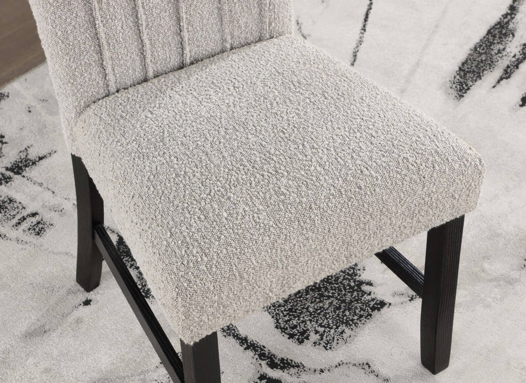 Detailed view of boucle fabric texture and cushioned seat on dining chair from the Genuine Marble Dining Table Set.