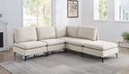Beige linen upholstered modular sectional sofa with plush cushions and modern black metal legs in a bright living room.