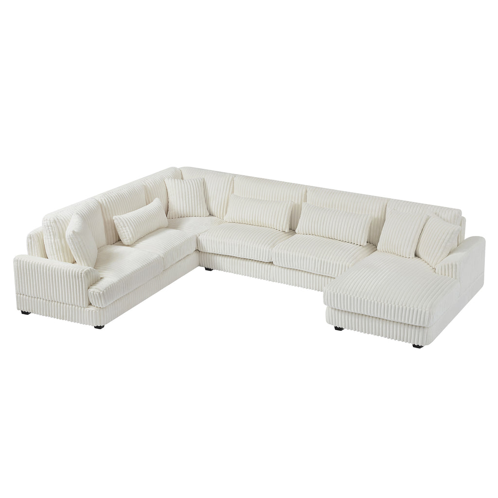 Modern oversized U-shaped sectional sofa in beige corduroy with a chaise lounge and plush matching throw pillows.