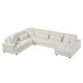 Modern oversized U-shaped sectional sofa in beige corduroy with a chaise lounge and plush matching throw pillows.