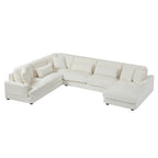 Modern oversized U-shaped sectional sofa in beige corduroy with a chaise lounge and plush matching throw pillows.