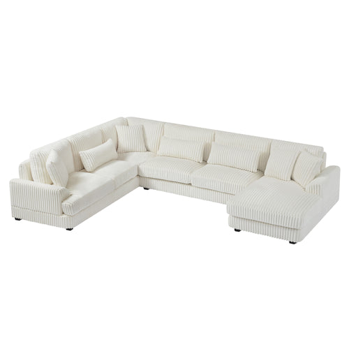 Modern oversized U-shaped sectional sofa in beige corduroy with a chaise lounge and plush matching throw pillows.