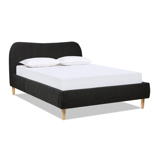 Curved Upholstered Platform Bed Queen, Ebony Black Boucle with plush headboard and light wood legs, shown with white bedding.