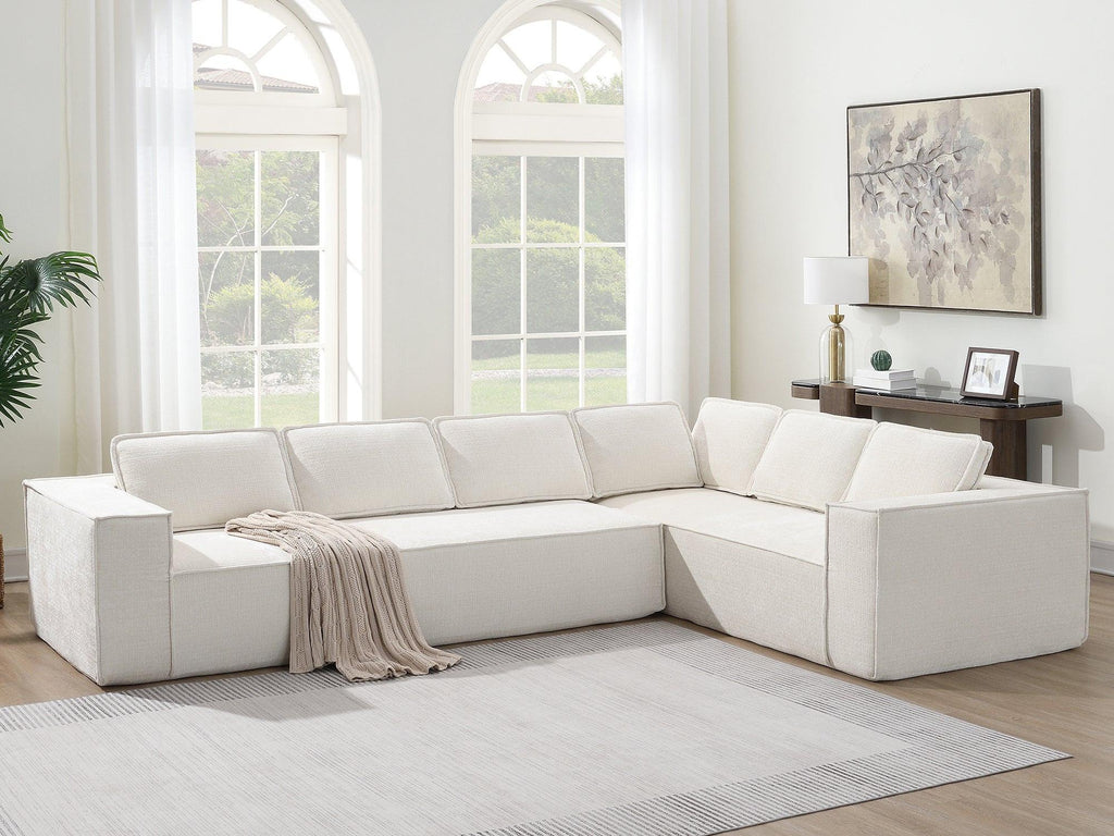 Full view of modular sectional sofa in wrinkle-resistant chenille, placed in bright living room with neutral decor and large windows.