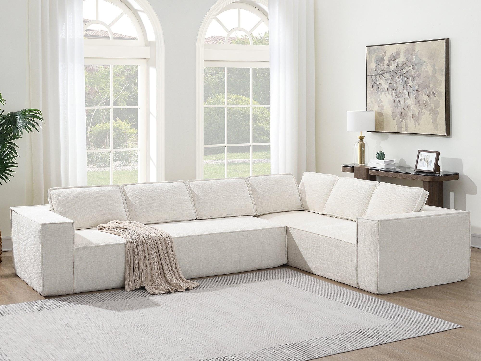 Full view of modular sectional sofa in wrinkle-resistant chenille, placed in bright living room with neutral decor and large windows.