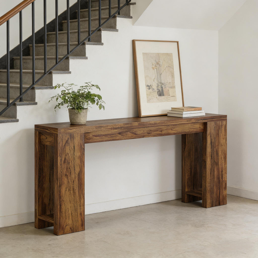 Minimalist dark brown wooden console table with a thick, sturdy frame, placed against a wall by a staircase.
