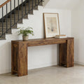 Minimalist dark brown wooden console table with a thick, sturdy frame, placed against a wall by a staircase.