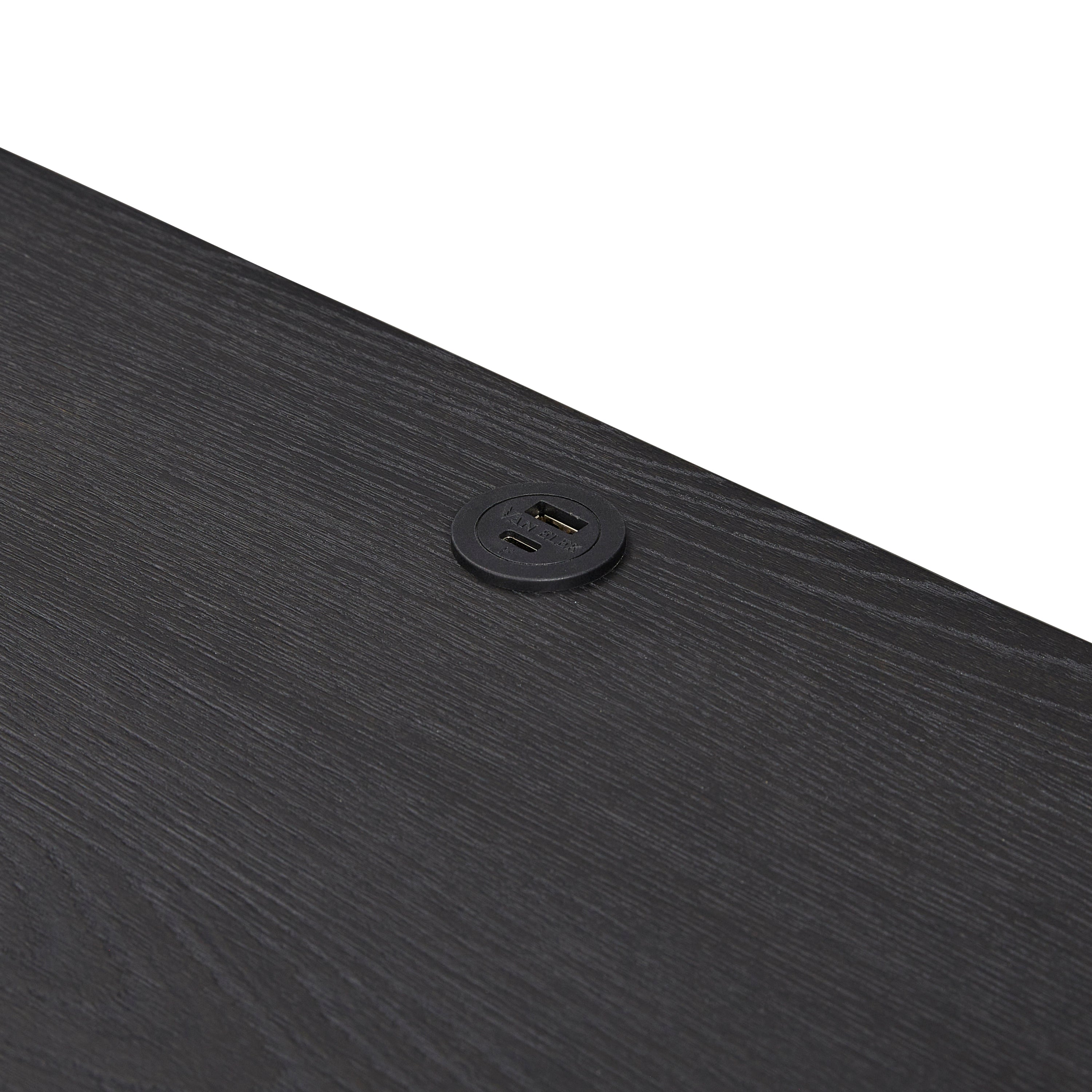 Top surface of black wood nightstand featuring built-in USB ports for convenient device charging in bedroom settings.