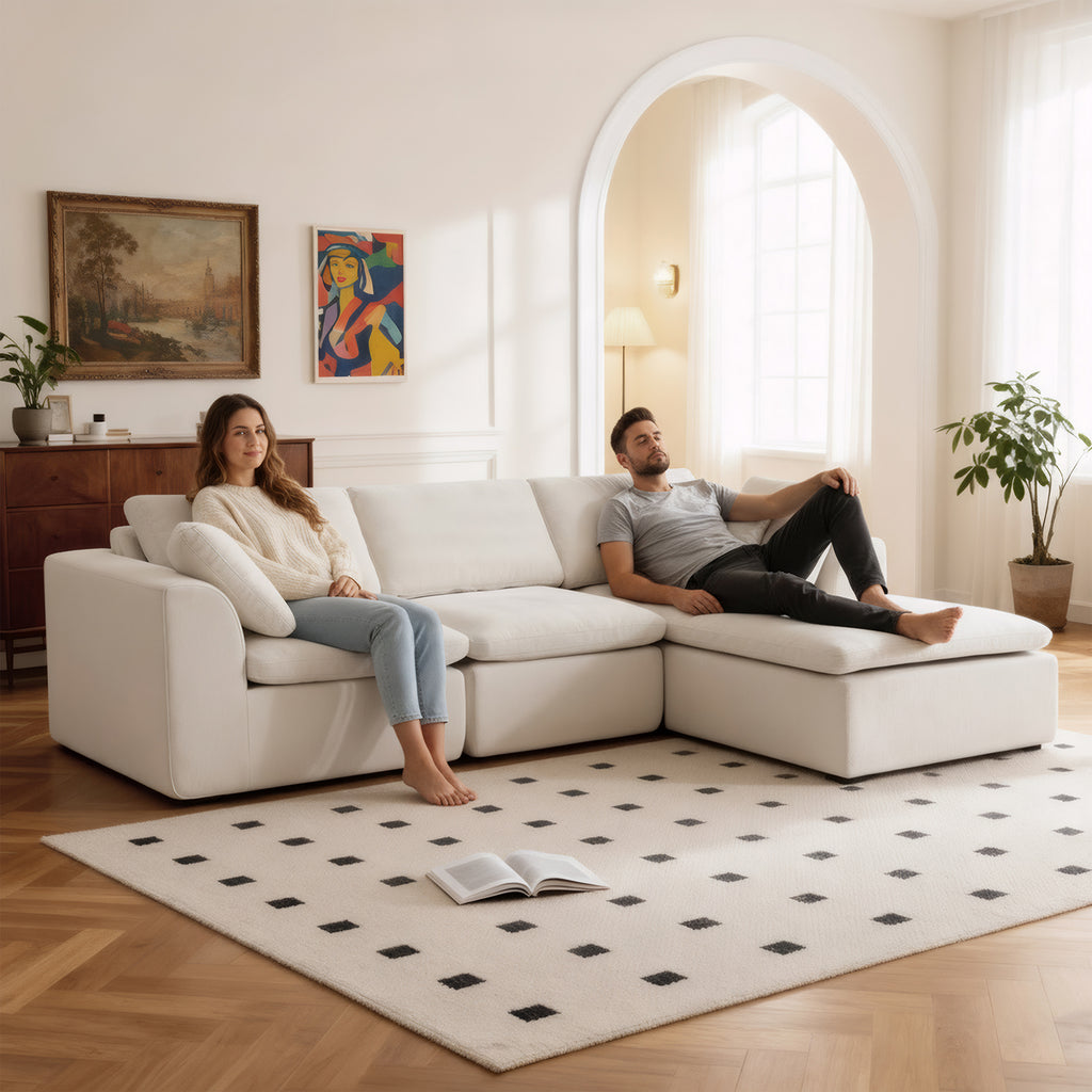 L-Shaped Sectional Sofa in modern style with chaise lounge, chenille fabric and modular seating, shown with two people relaxing in a cozy setting.