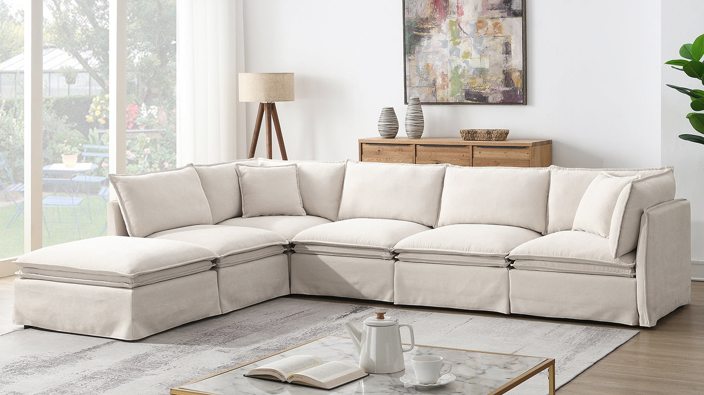 Versatile modular sectional sofa with ottoman in a modern living room, offering flexible seating and neutral tones for stylish interiors.