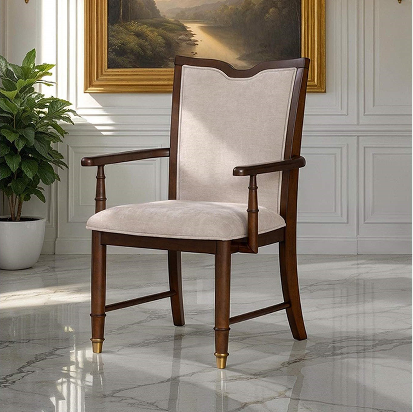 Transitional dining arm chair with beige upholstery, dark cherry wood frame, and gold capped legs in elegant room setting.