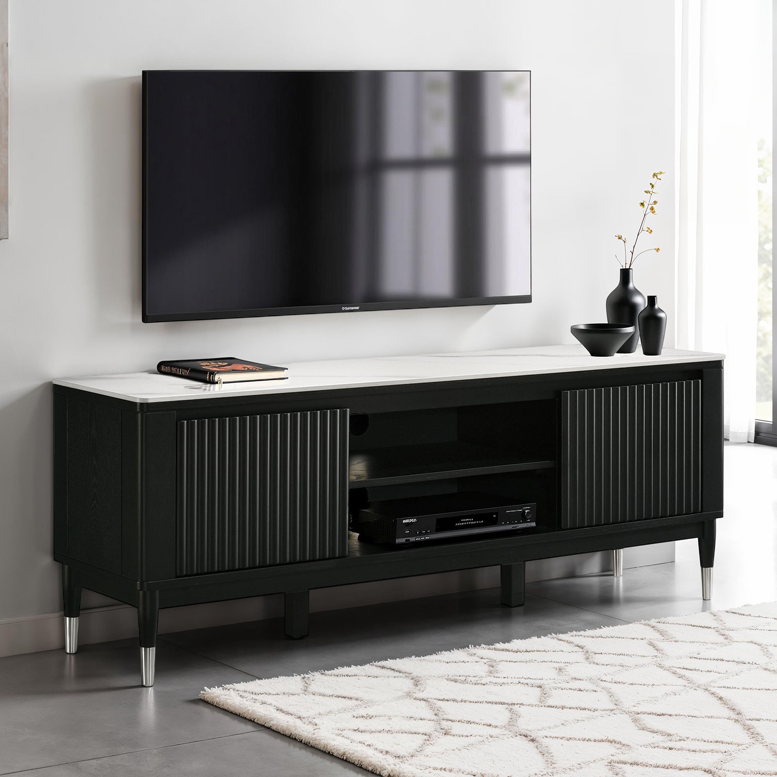 Modern style TV console with sintered stone surface, black fluted doors, and open center shelves, ideal for sleek living room setups.