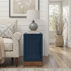 Nora Chairside Table Blue Finish | No Assembly, Wood next to patterned armchair in cozy room with wood flooring and neutral decor.
