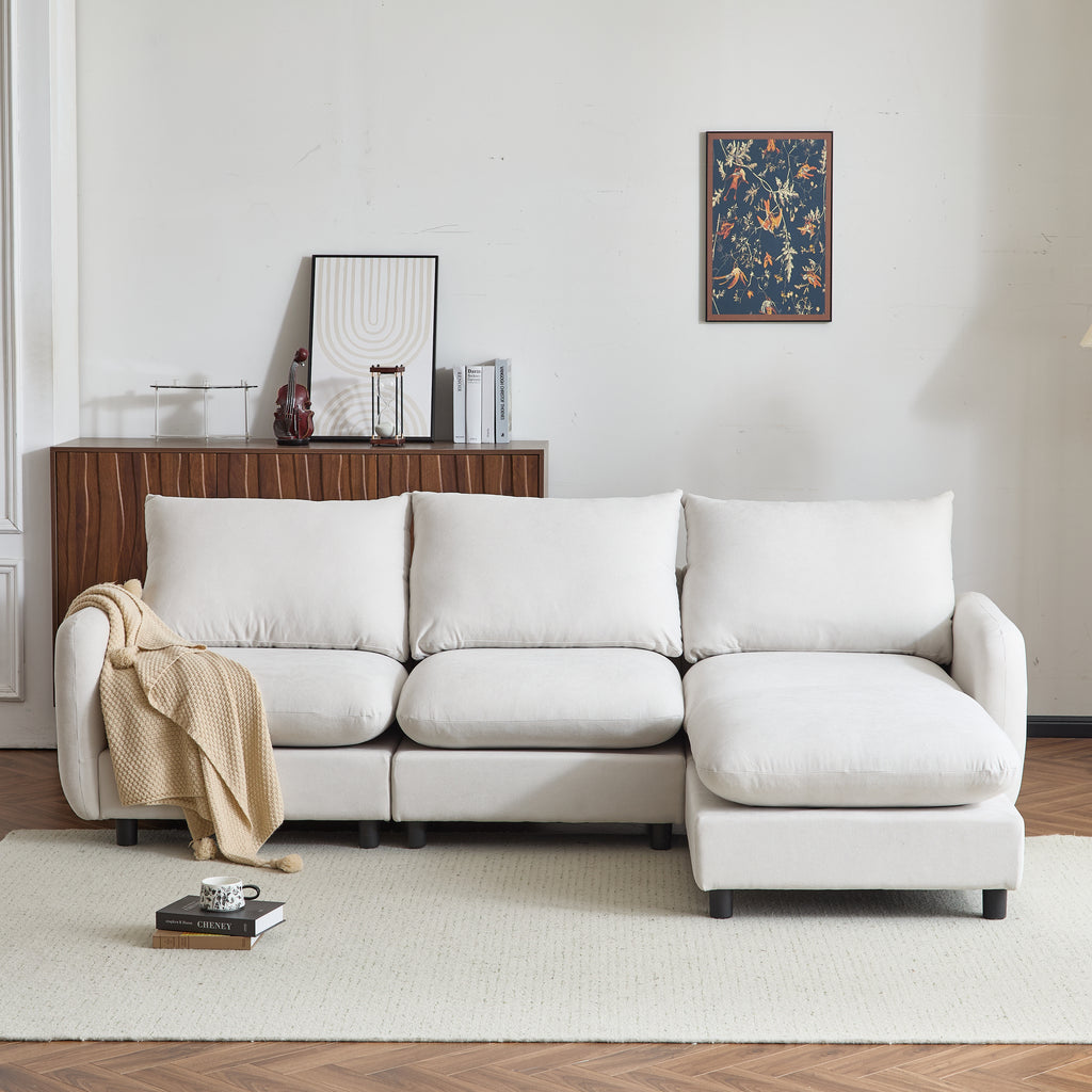 Front view of 99 in. L shaped modular sectional sofa couch with ottoman, featuring plush white cushions and a cozy throw blanket.