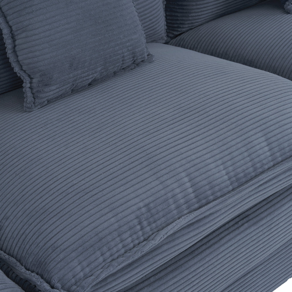 Detailed view of the blue corduroy seat cushion with ribbed texture. Designed for comfort and modern aesthetics in living room furniture.