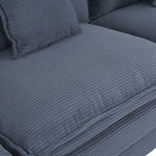 Detailed view of the blue corduroy seat cushion with ribbed texture. Designed for comfort and modern aesthetics in living room furniture.