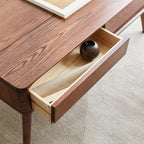 Close-up of oak wood coffee table drawer with smooth sliding mechanism and natural wood interior.