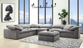 Modern gray linen modular sectional sofa with deep, plush seating and matching ottoman on a patterned area rug.