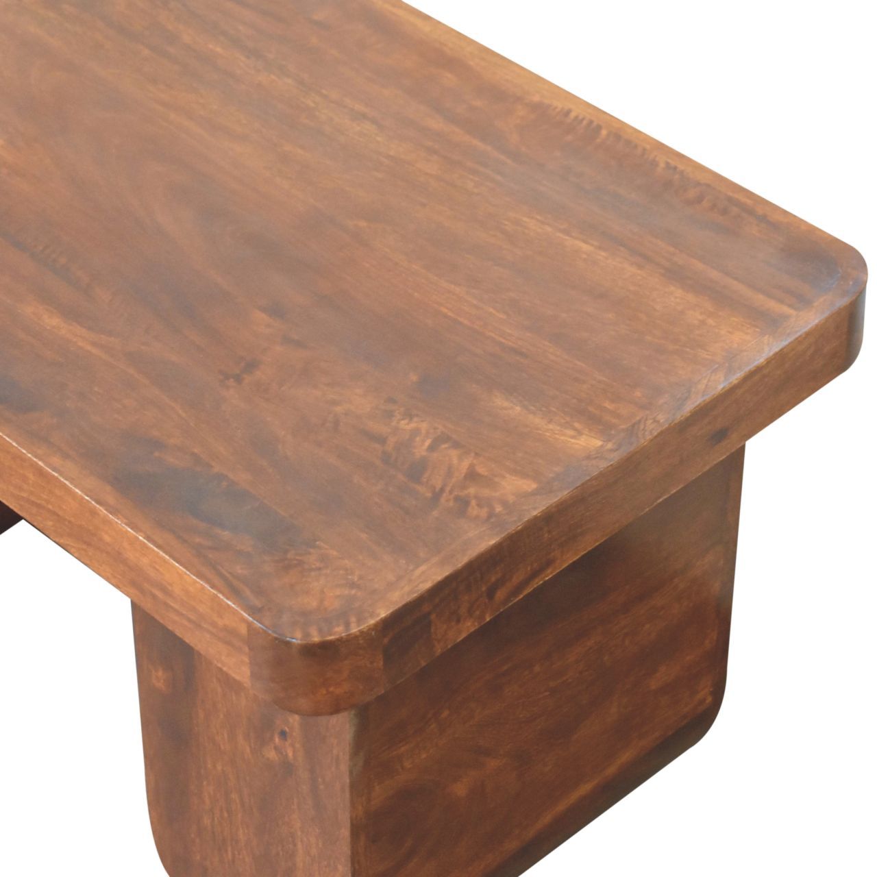 Close-up of chestnut-finished mango wood tabletop showing smooth grain and thick solid wood construction.