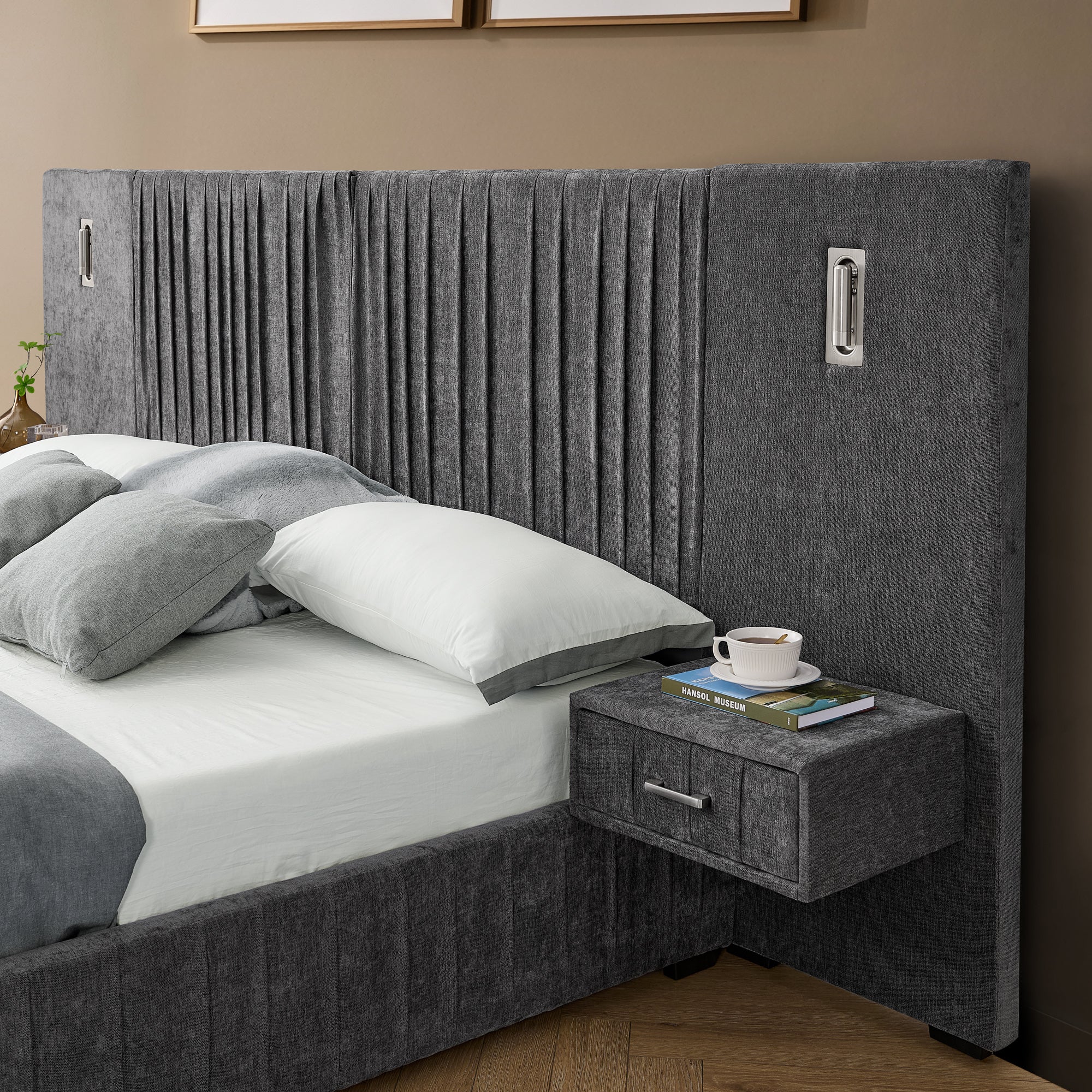 Detail of built-in bedside table on queen upholstered bed. Features drawer storage and integrated lamp with pleated headboard design.