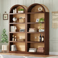 Two farmhouse arched bookshelves in walnut and natural wood with five open tiers and fabric-lined top detailing.