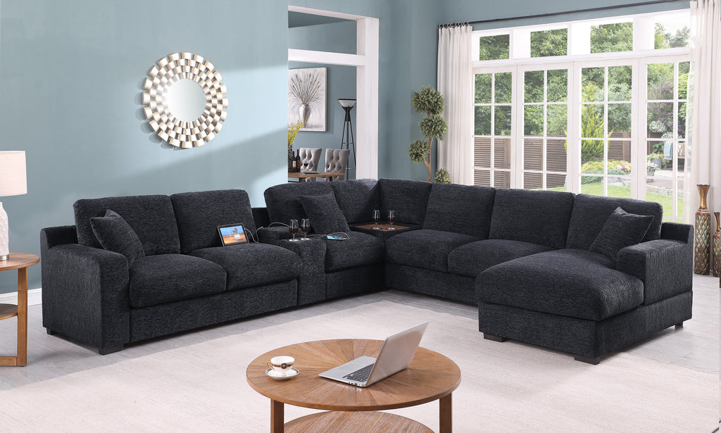 Celine sectional sofa in dark gray with chaise, cupholders, and USB ports in a modern living room. Features modular design and plush cushions.
