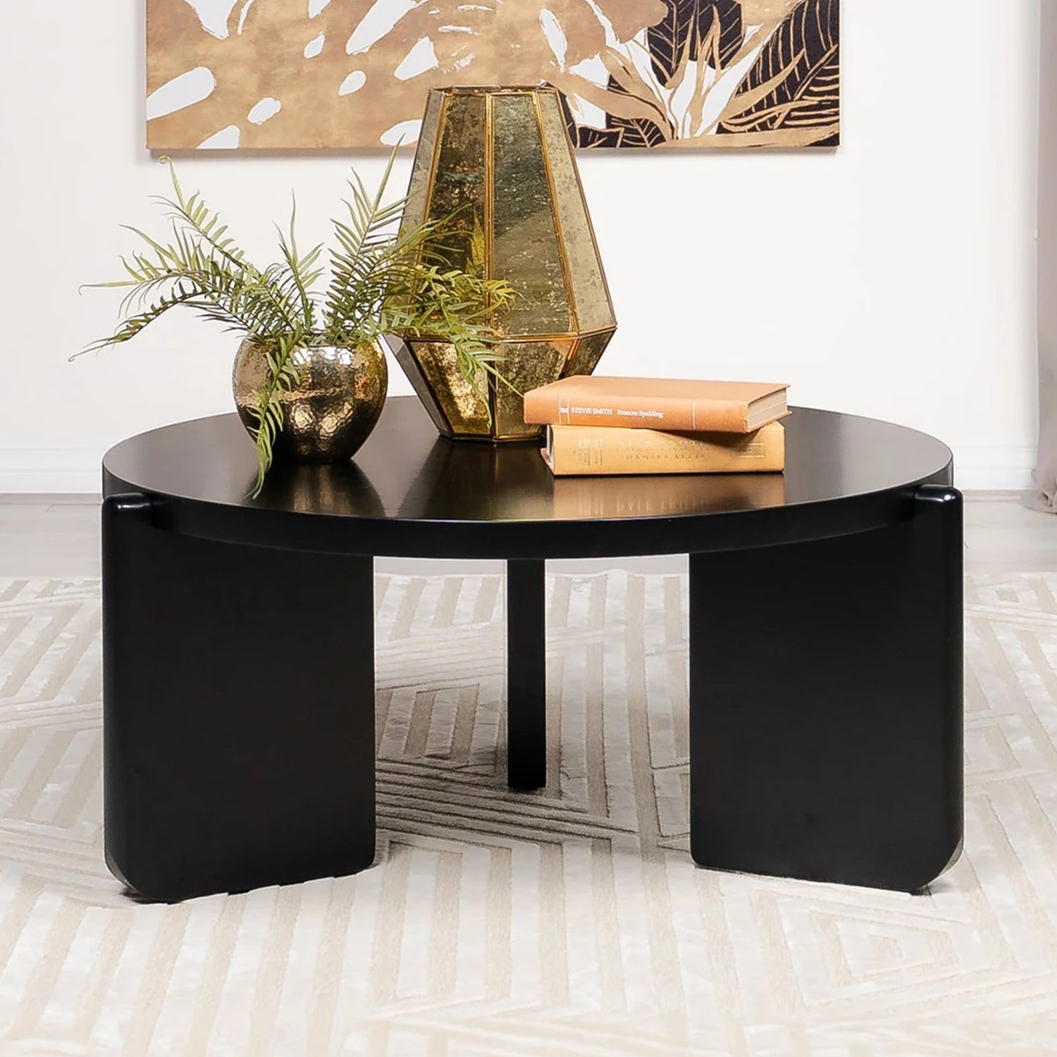 Black round wooden coffee table styled in a modern living room with gold decor accents, perfect for enhancing elegant interiors.
