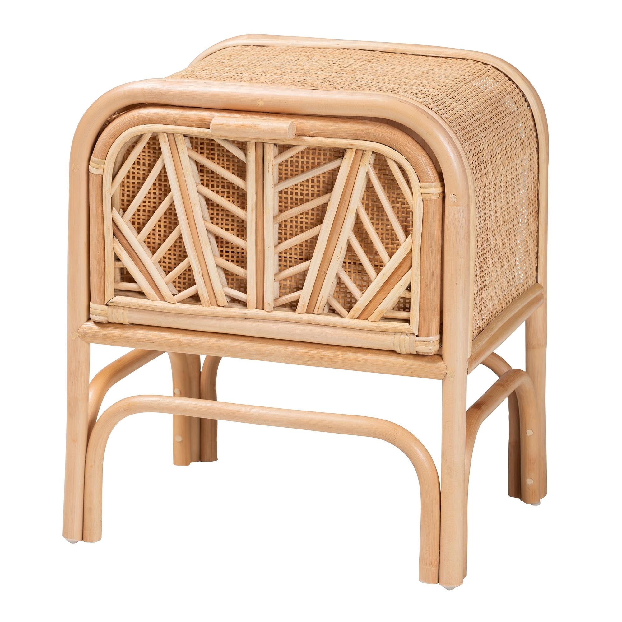 Boho-style natural rattan nightstand with curved frame, woven top, and cabinet door with geometric inlay detail.