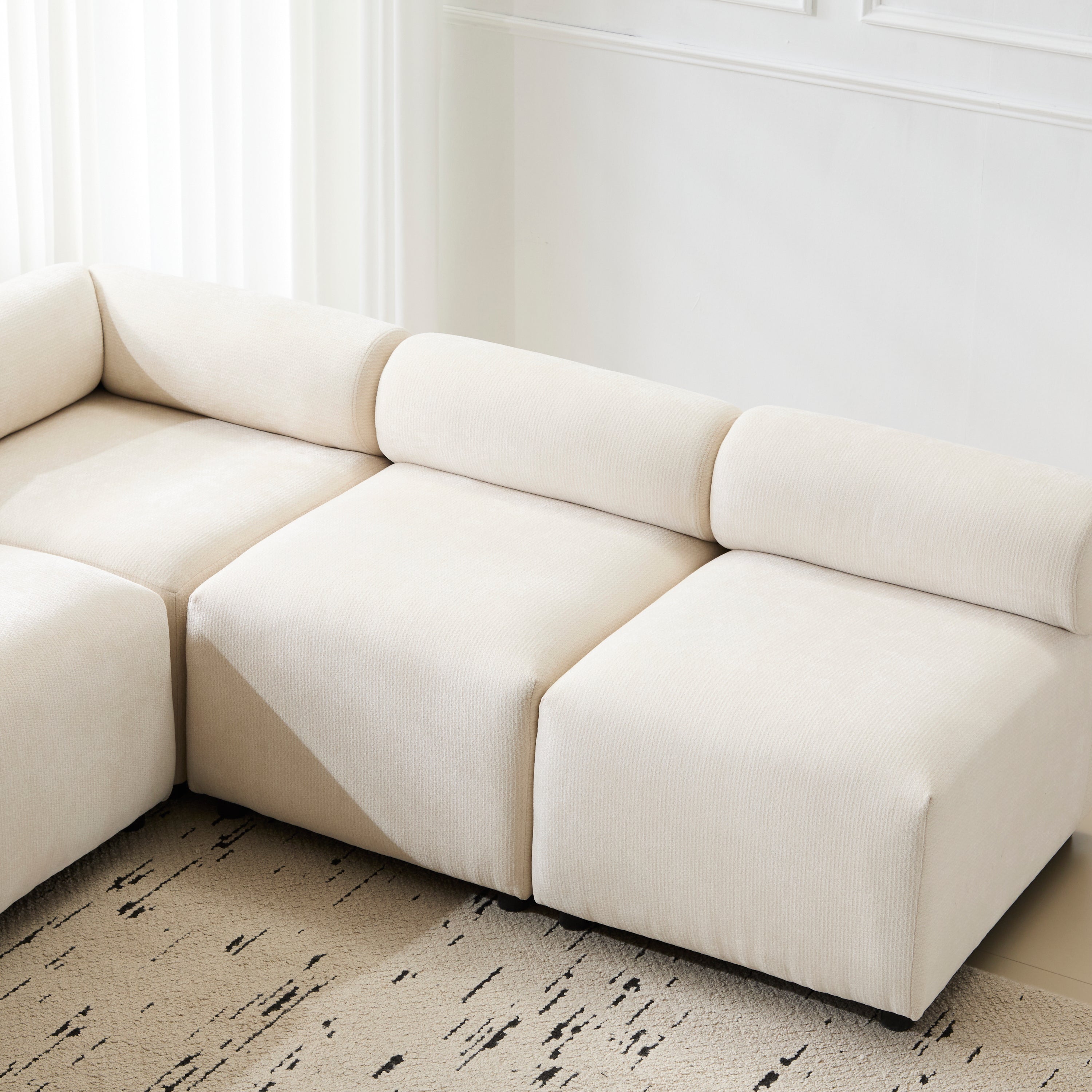 Close-up of Evelyn 83'' modular chenille sectional sofa highlighting plush seating and soft textured fabric.