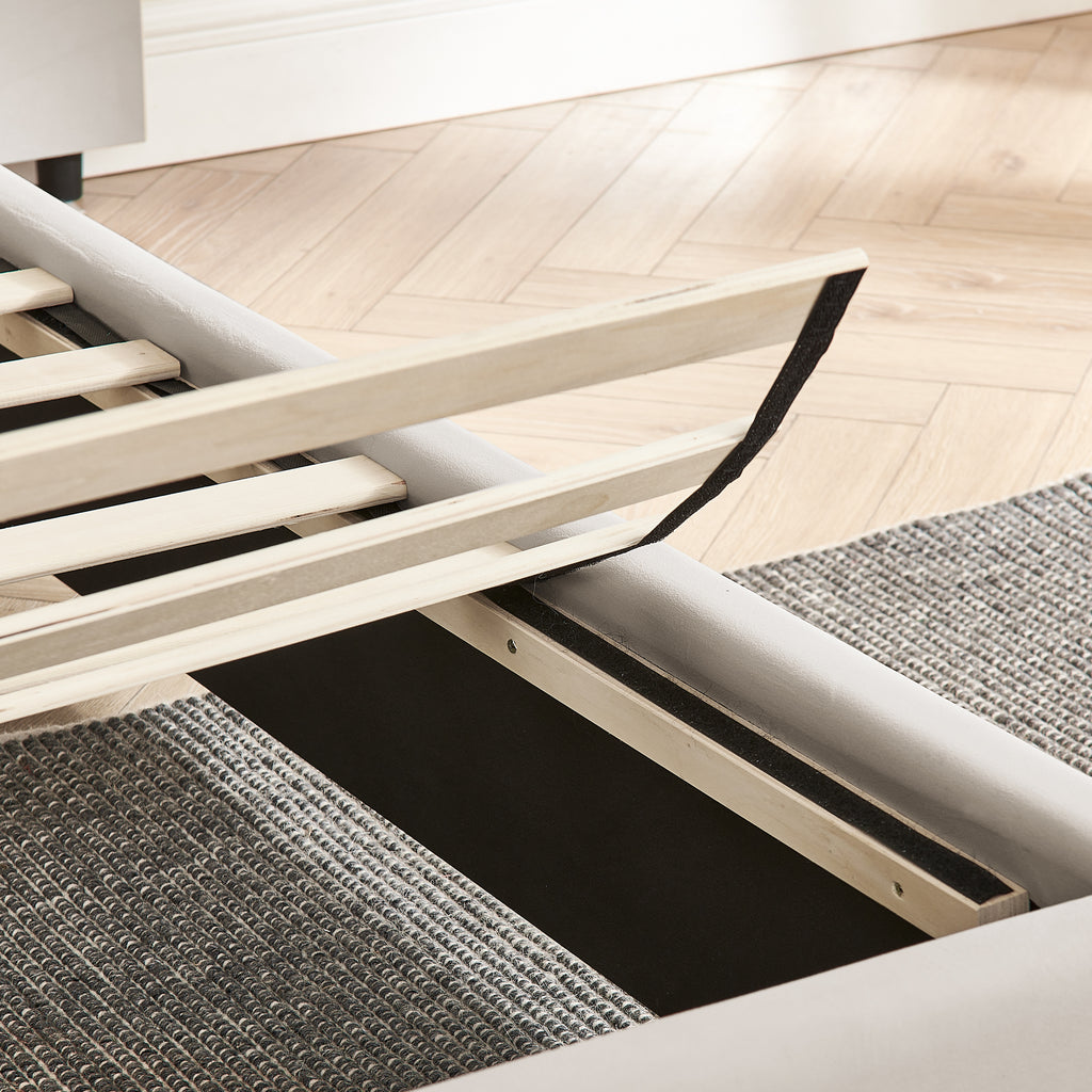 Slatted wood support system of king bed frame with no box spring needed, ensuring durability and mattress ventilation.