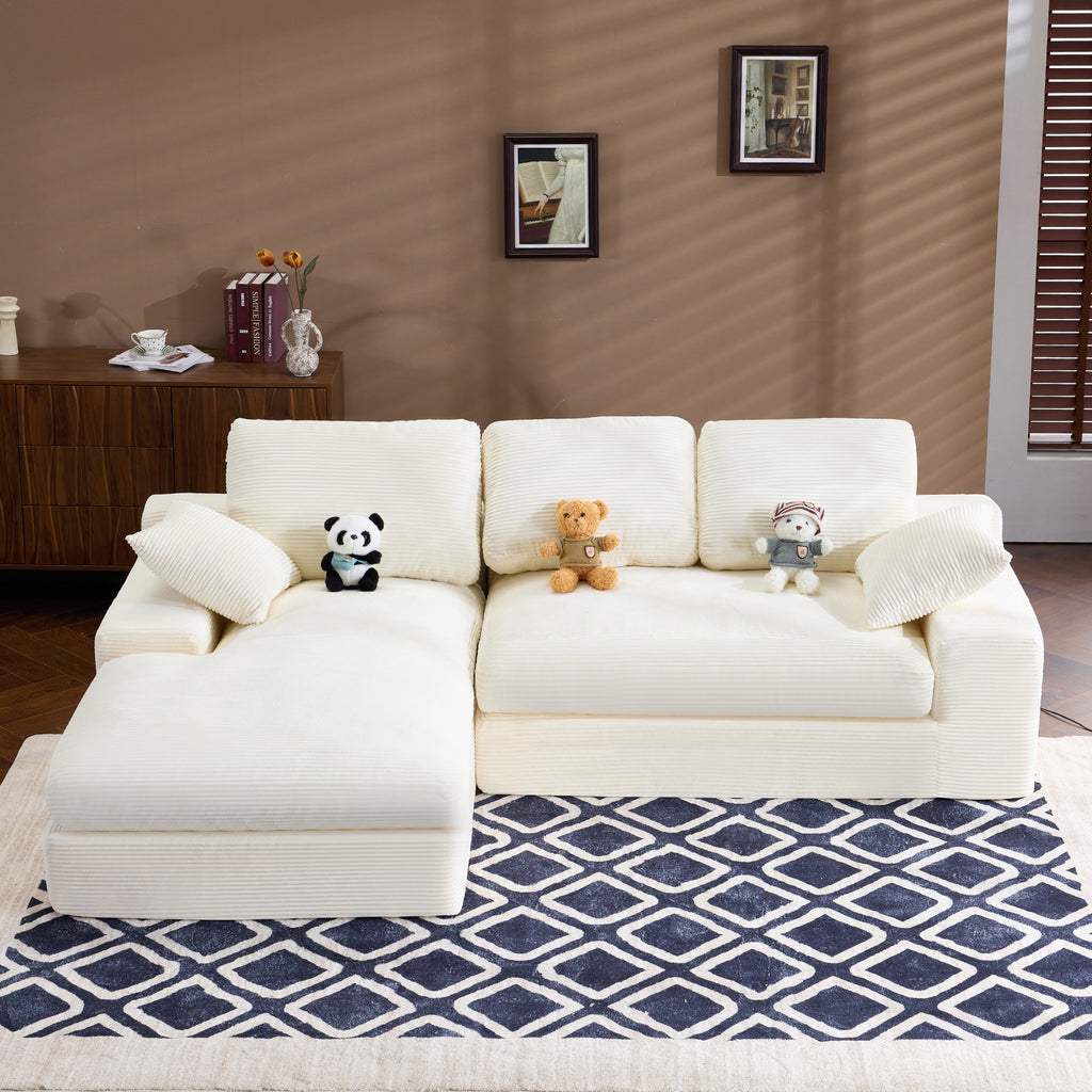 White Corduroy Sofa with 4 seats, 3 back cushions, and 2 pillows, placed on a patterned rug in a modern living room.