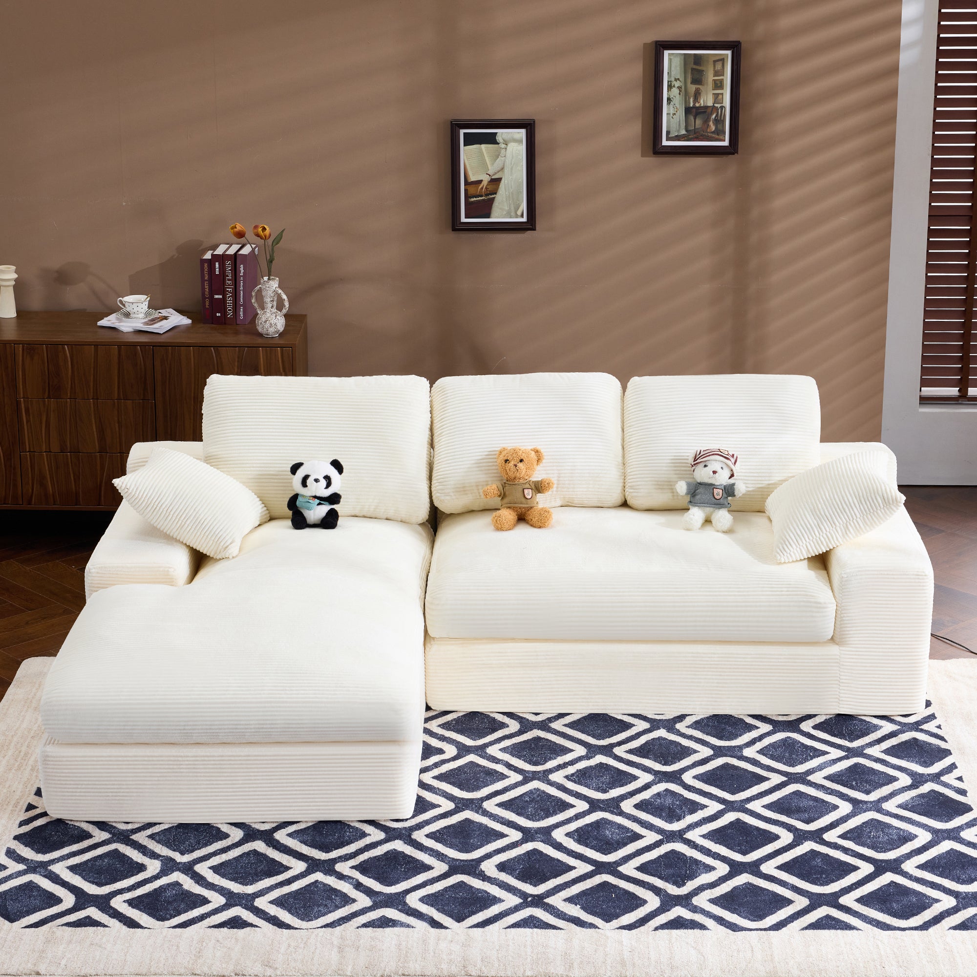 White Corduroy Sofa with 4 seats, 3 back cushions, and 2 pillows, placed on a patterned rug in a modern living room.