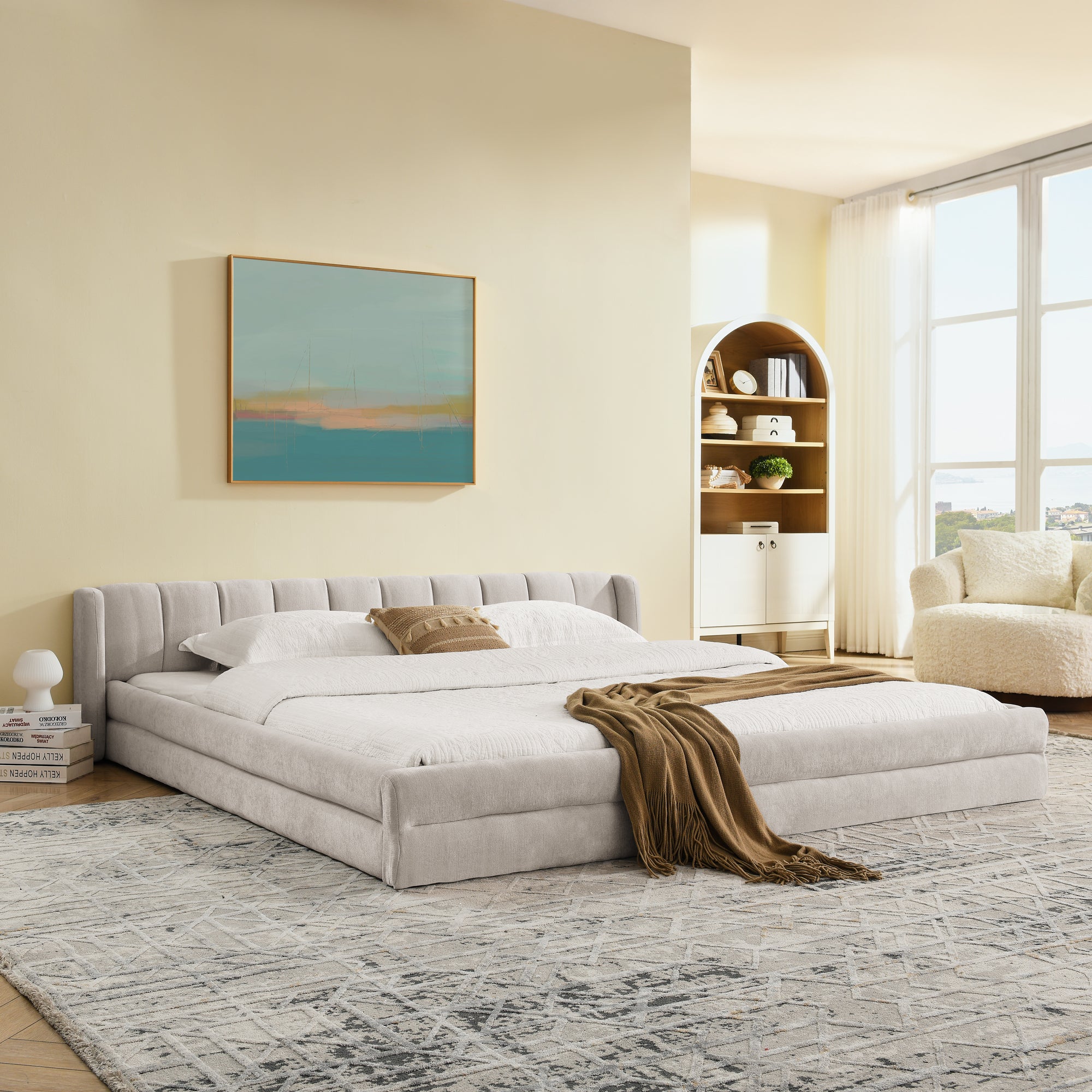Chenille upholstered king bed in a modern bedroom with natural light, showcasing its low-profile frame and cozy design.