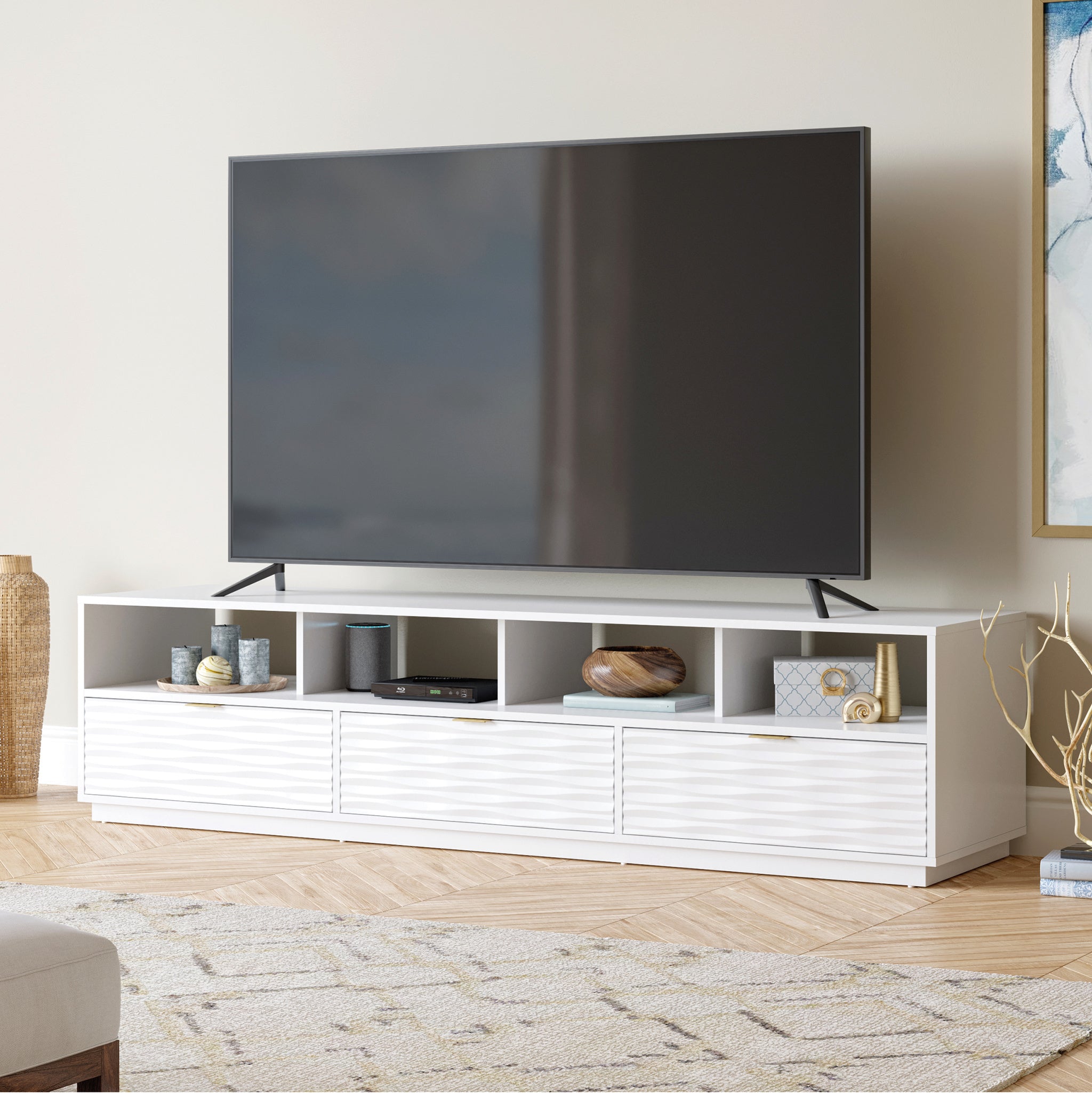 White Coastal Credenza in a living room setting with large TV, offering elegant storage and display for modern home entertainment.