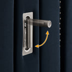 Adjustable reading light on navy velvet headboard of queen upholstered bed frame with built-in lighting feature.