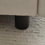 Close-up of the black cylindrical leg of the 69 in. 2-Seats Modular Sectional Sofa Corner Chair Sofa Couch on a woven rug.