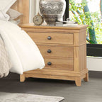 Farmhouse Oak Nightstand styled in cozy bedroom. 3-drawer wood nightstand with felt-lined drawer and rustic black knobs.