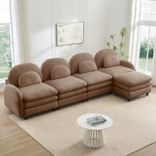 Camel teddy fabric 4-seater modular sofa with curved backrests, lumbar pillows, and a movable ottoman.