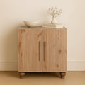 Modern sideboard in solid sandgrain pine and mango wood with two doors, long silver handles, and rounded wooden feet.