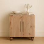 Modern sideboard in solid sandgrain pine and mango wood with two doors, long silver handles, and rounded wooden feet.