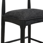 Detailed view of black fabric bar stool seat and frame, emphasizing quality craftsmanship and modern aesthetic.