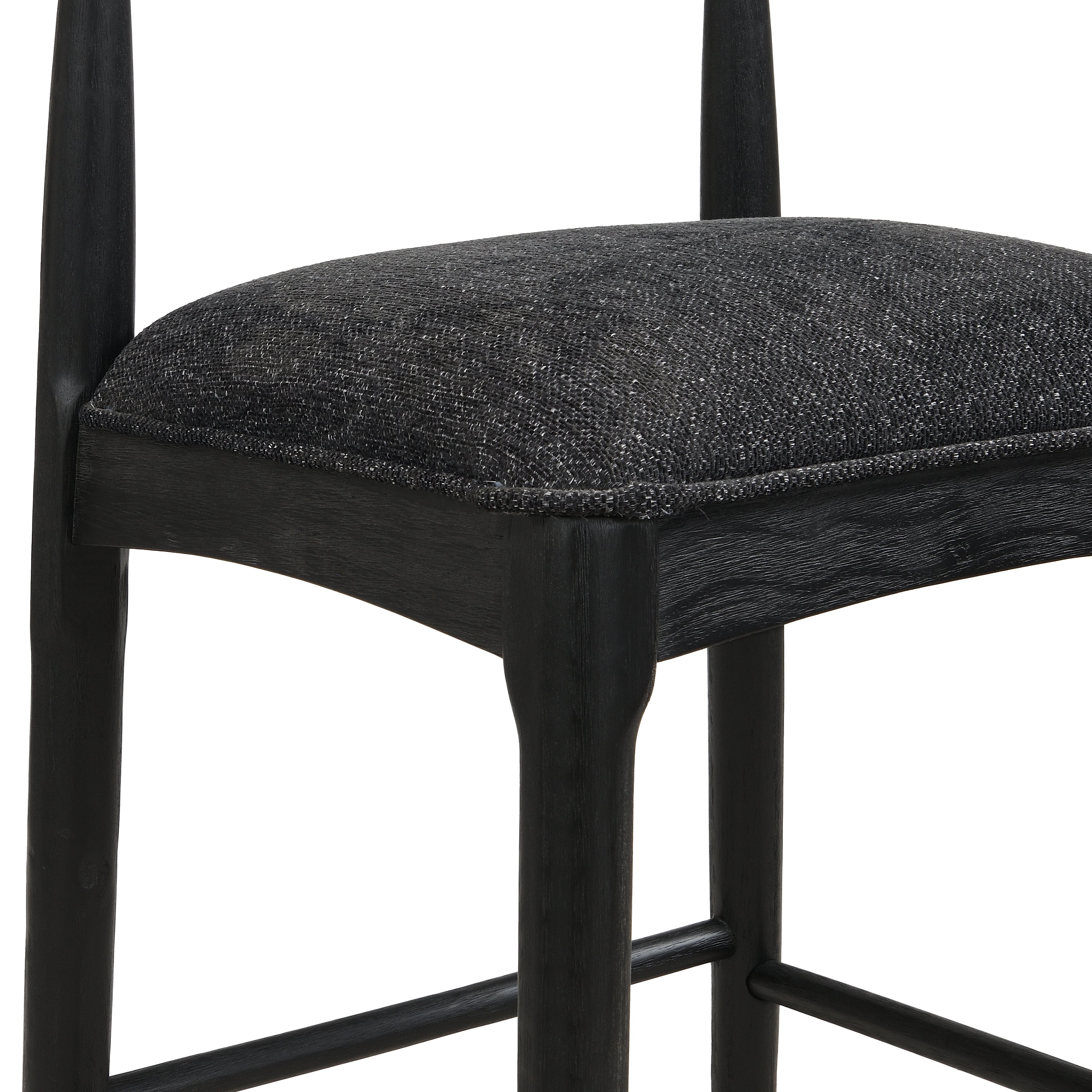 Detailed view of black fabric bar stool seat and frame, emphasizing quality craftsmanship and modern aesthetic.