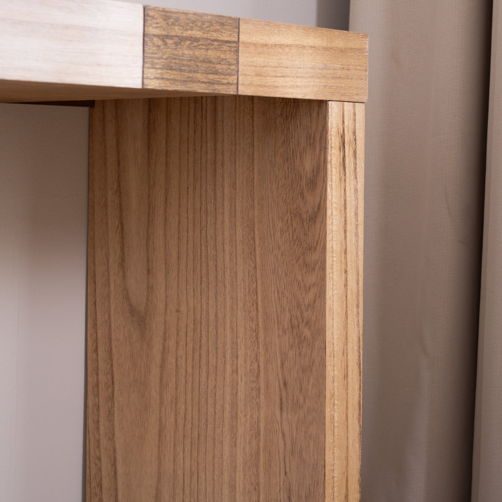 Close-up of leg on modern console table with chevron top, showing natural wood grain and smooth finish.