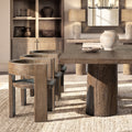 Sculptural dining chair in medium-dark reclaimed elm with a curved back, rustic texture, and modern architectural frame.