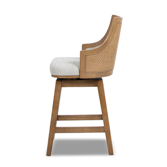 Side view of Bahama 26' Rattan Swivel Counter Stool with cane paneling and cushioned seat in gray polyester wool blend for stylish bar seating.